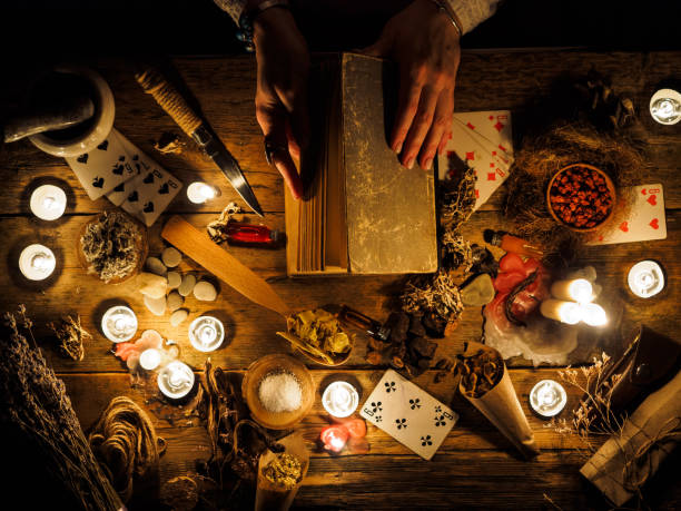 In the hands of fortune tellers old book with spells. The attributes of the occult.